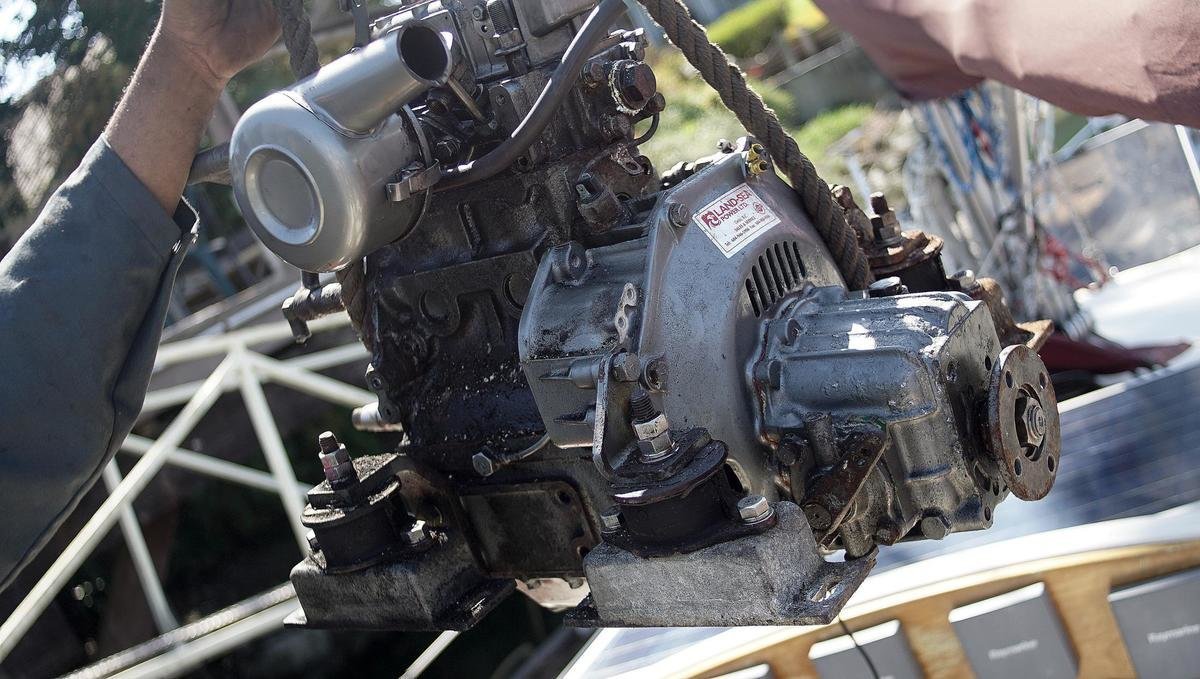 A closeup photo of a diesel engine lifted out of its compartment
