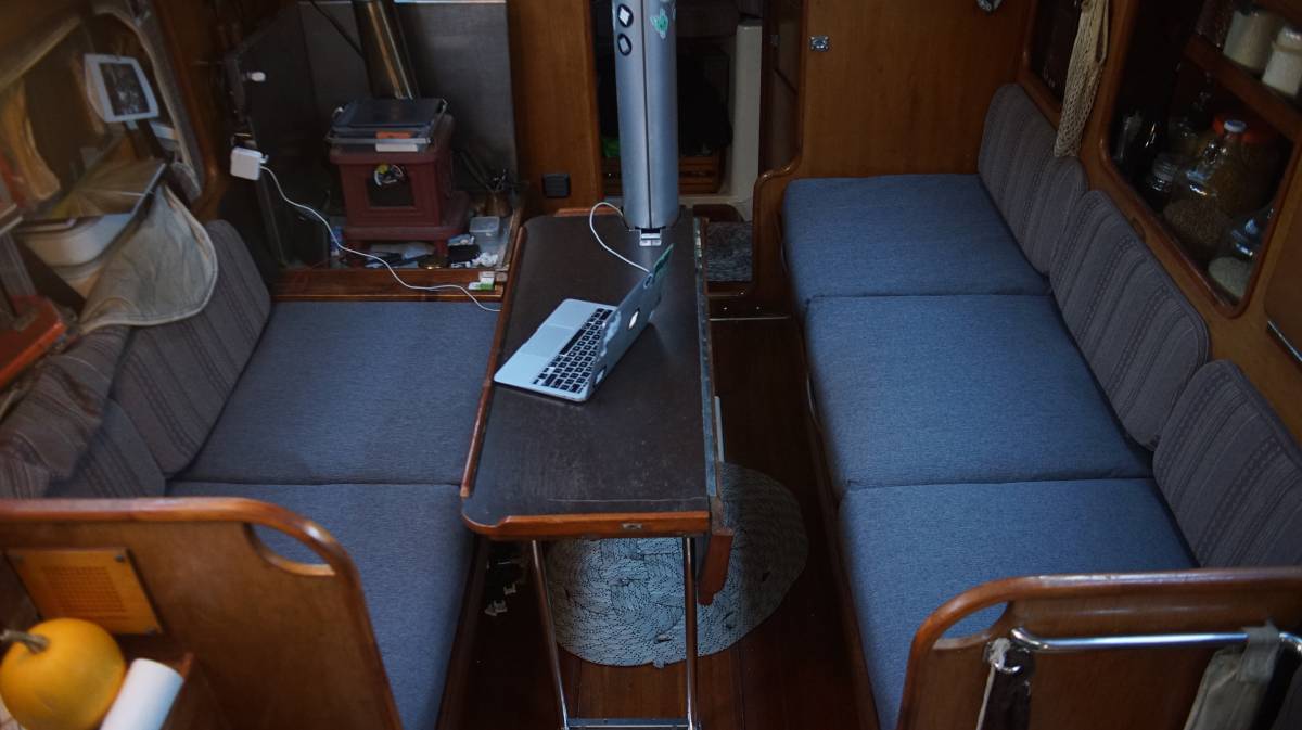 saloon with new seat cushions, old fabric visible on back rests