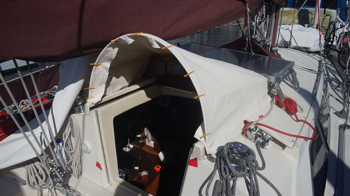 a test fit for fabric over a metallic arch on the deck of a sailboat