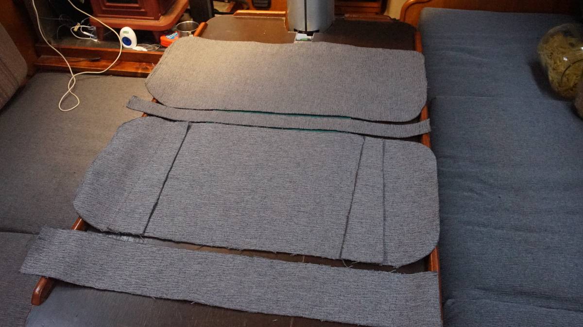 all of the cut fabric pieces needed to make a backrest laying over a table