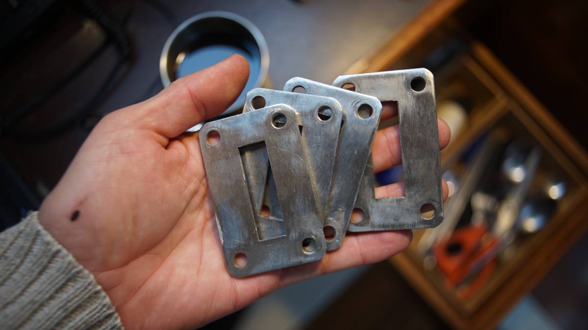 the new machined plates held in the palm of a hand