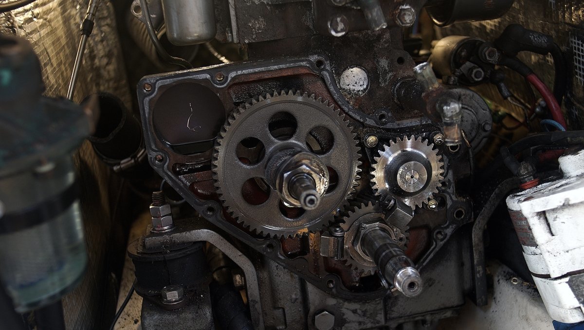 A photo of a Yanmar2gm engine in the engine compartment of a sailboat, it is missing many pieces