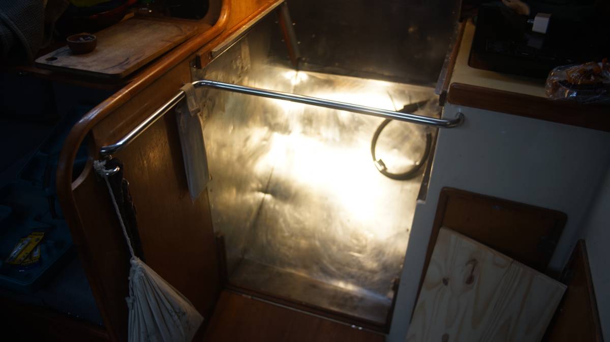 an empty space in the galley, covered in thin stainless steel sheeting