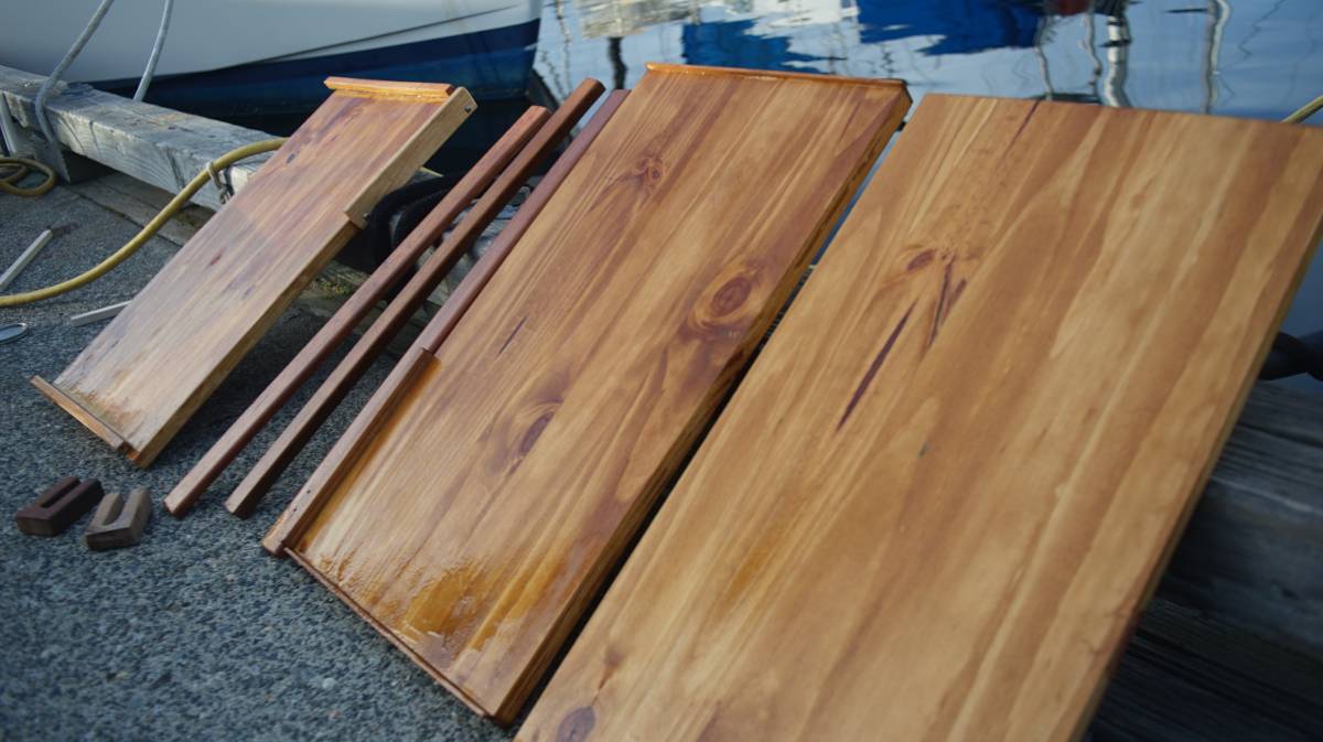 cut pieces of coffee-stained pine drying on the dock