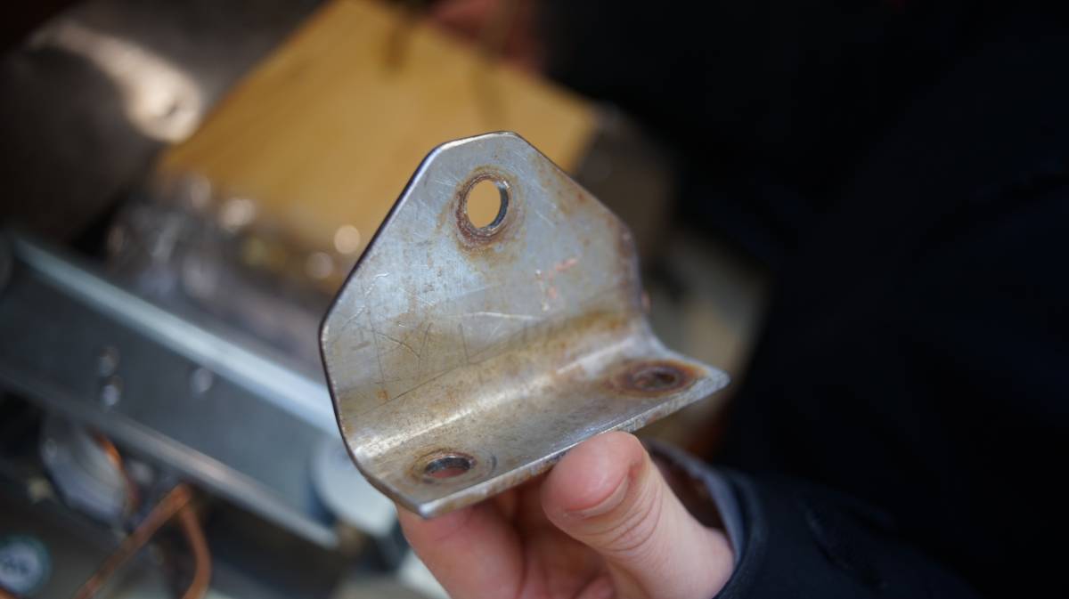 a hand holding a heavy duty stainless steel bracket