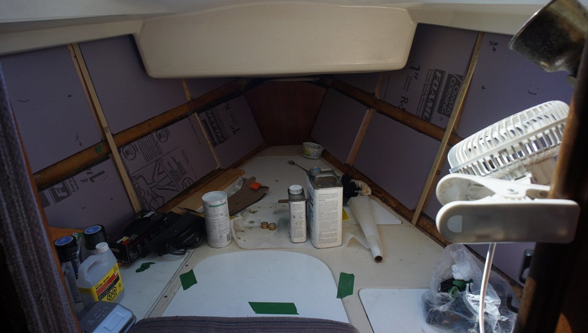 a photo of foam boards laying over the walls of a vberth inside a sailboat
