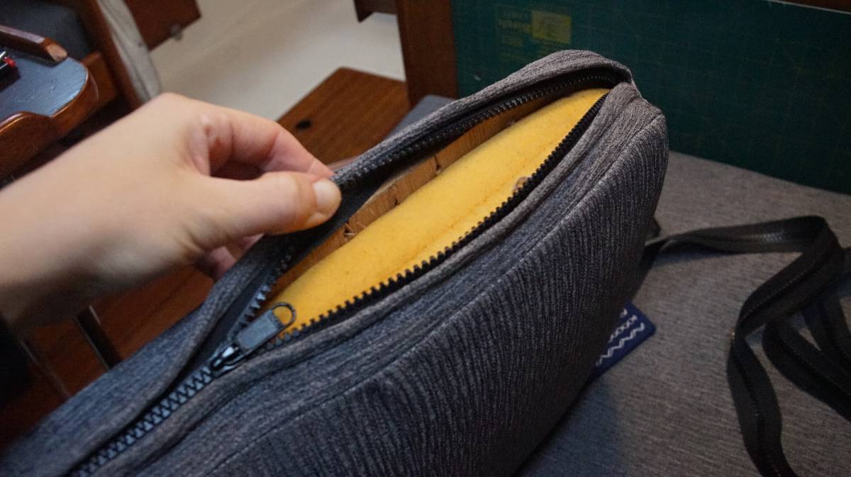 the backrest cushion zipper is opened to show the foam inside the cover