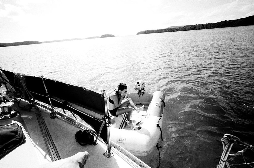 a photo of rekka in iggy the inflatable dinghy in a bay in the summer