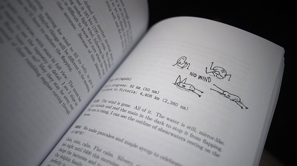 A paperback book is opened to a page featuring an illustration of cartoon character waiting for wind
