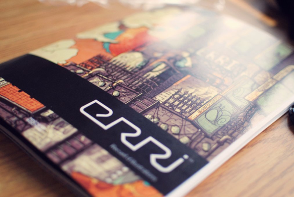 a close up photo of the Erri artbook, the cover is of a stylized fictional building