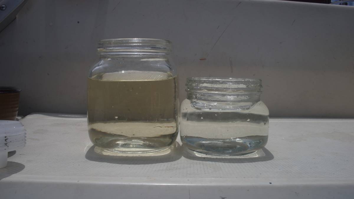 two jars of water, one has a yellow tinge and the other is clear