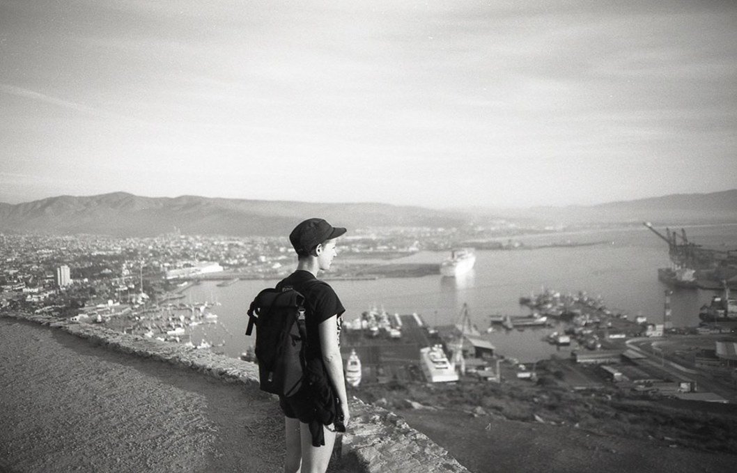 rekka standing on a mountain and looking at the port of Ensenada below