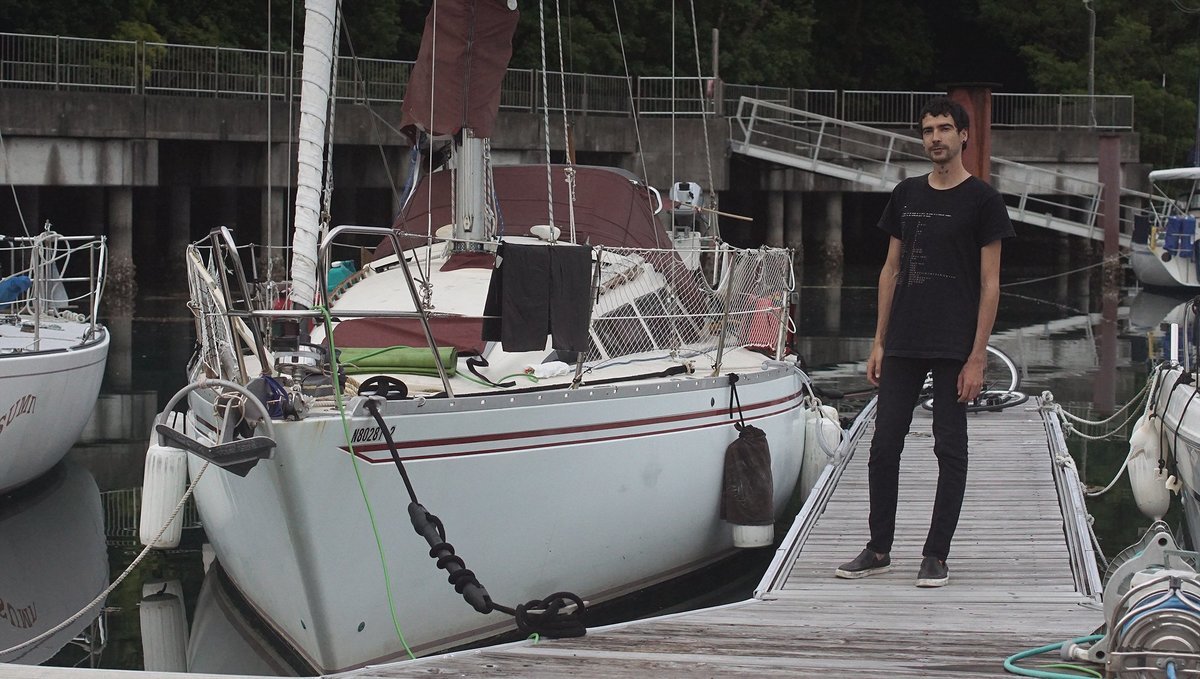 a photo of devine standing next to pino moored in shima yacht harbor