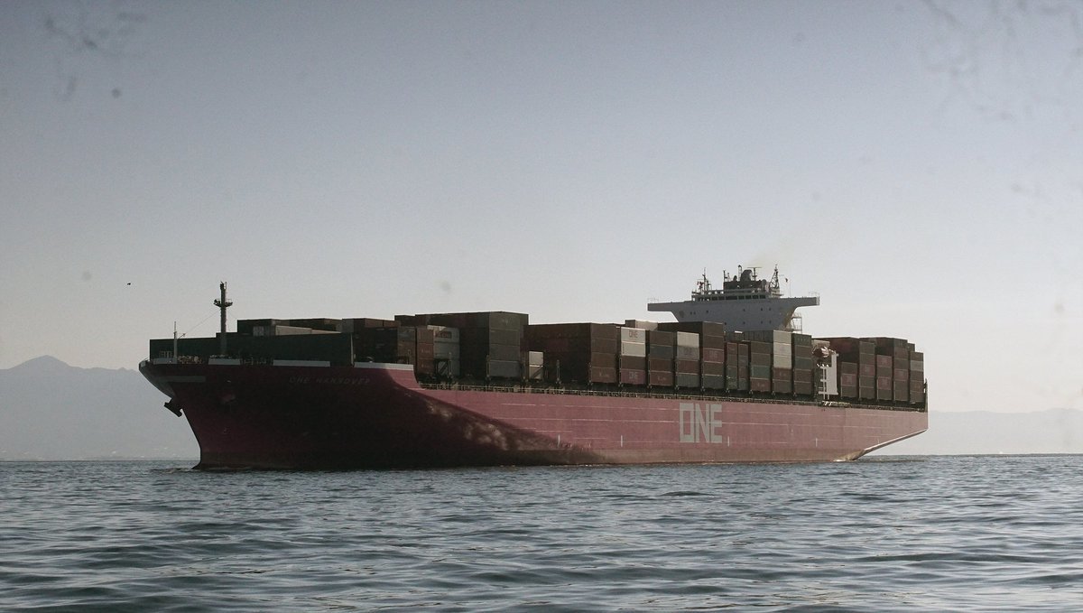 a large cargo ship entering a port in Japan