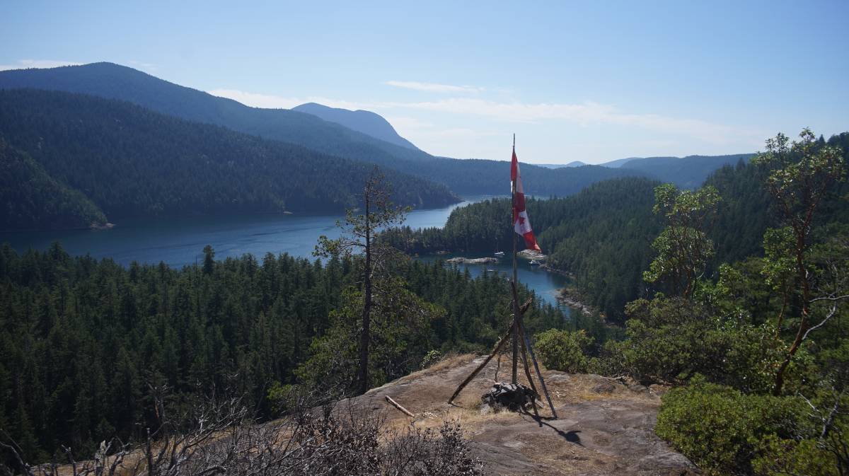 canadian flag atop the cliff