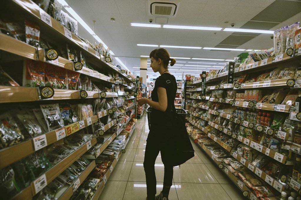 rek standing in the aisle of a japanese grocery store, deciphering labels