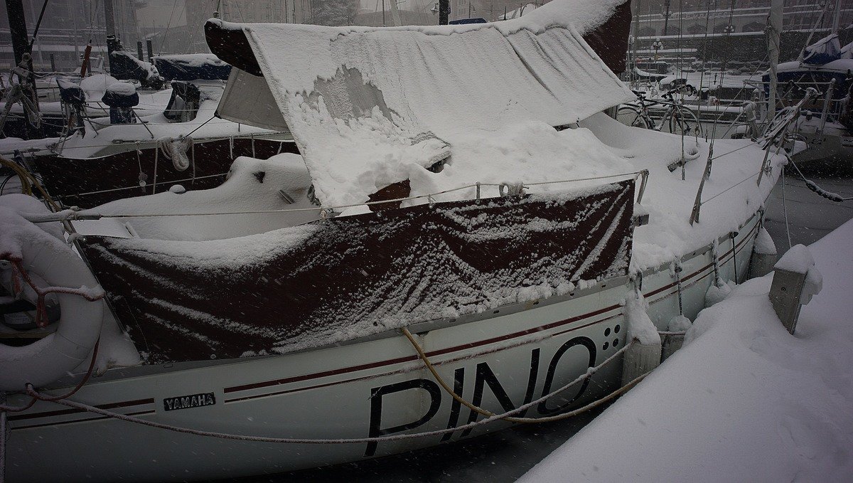a photo of a sailboat buried in snow